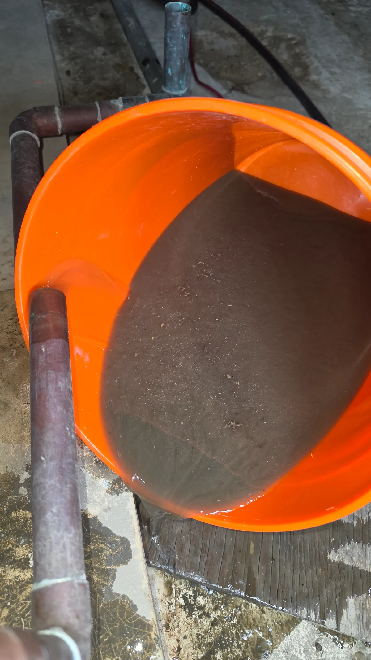 Progress photo showing bucket full of mud from coil during Commercial HVAC repair in Indian Wells, California