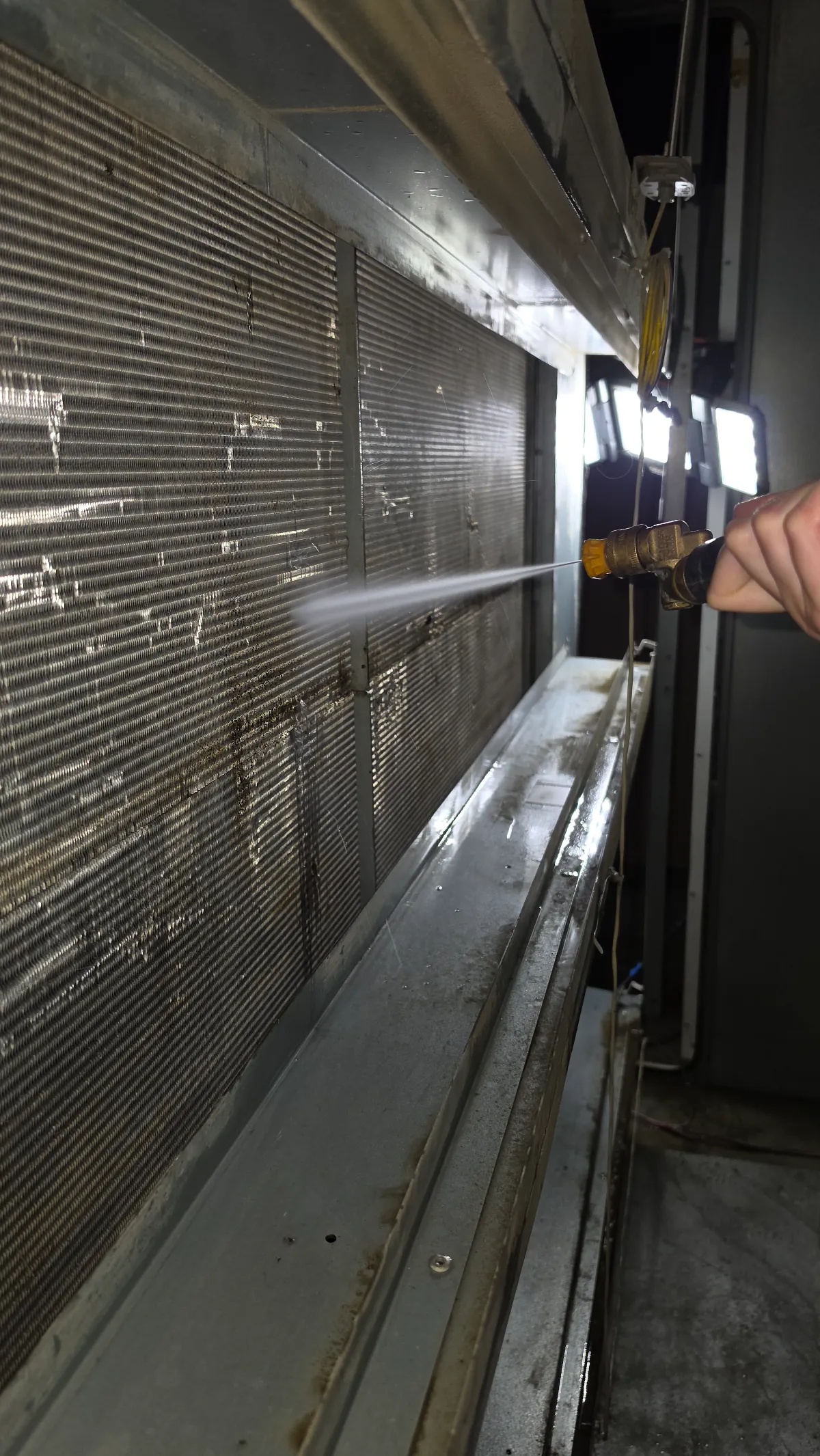 Progress photo showing Dee pressure washing during Commercial HVAC repair in Indian Wells, California
