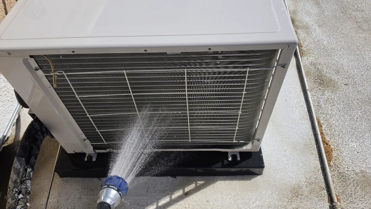 Progress photo showing Cleaning a condensing unit during Commercial HVAC maintenance in Palm Springs, California