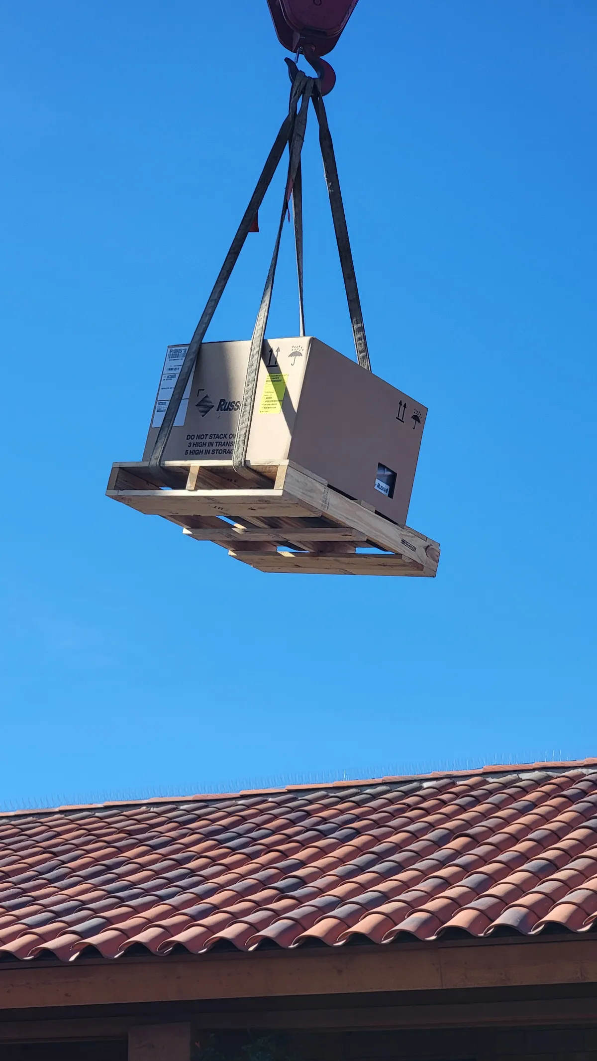 Progress photo showing Crane lift condensing unit during Commercial Refrigeration installation in Palm Springs, California
