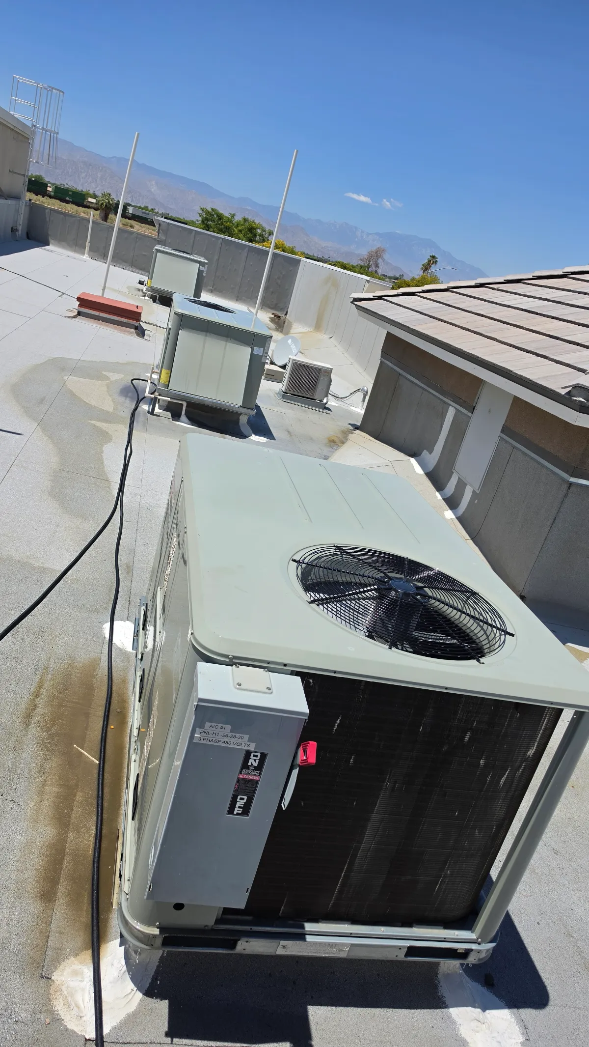 Progress photo showing maintenance on ac units during Commercial HVAC repair in Coachella, California