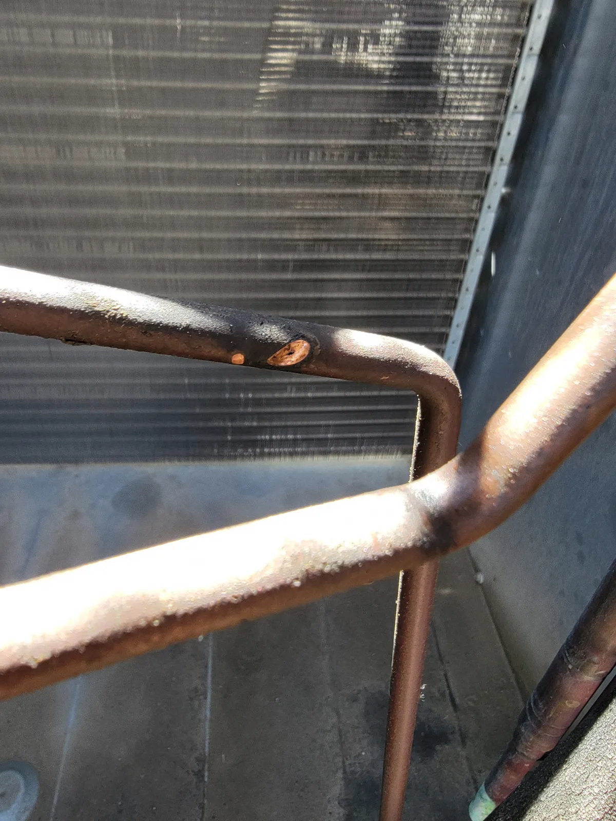 Progress photo showing visible hole from pipe during Commercial HVAC service in Cathedral City, California